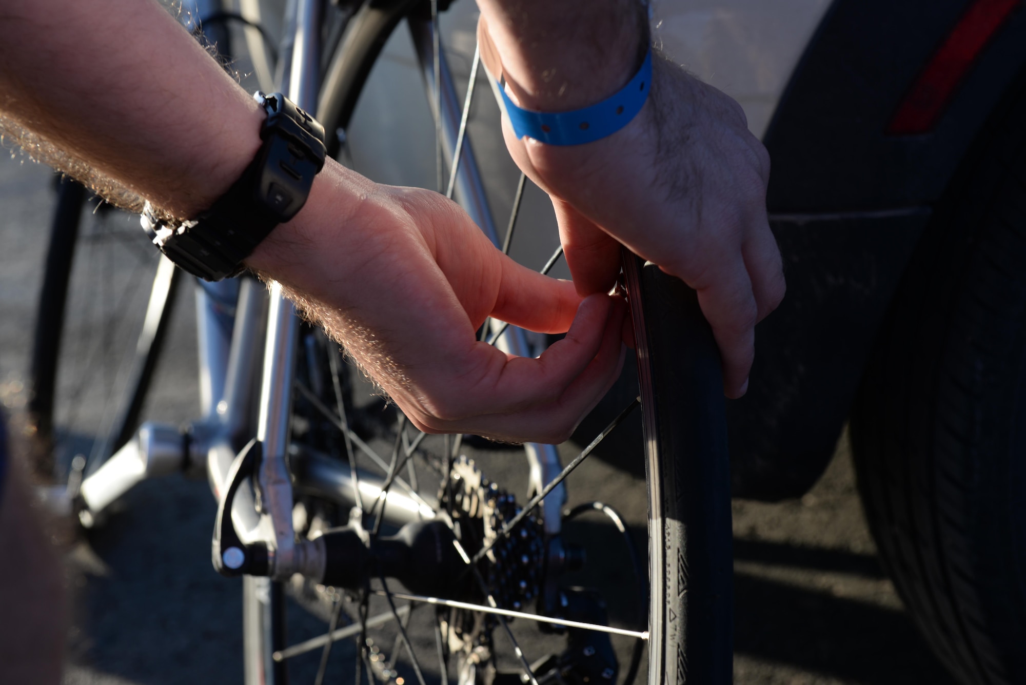 Capt. Eben Egler, a B-1 bomber weapon systems officer assigned to the 34th Bomb Squadron, checks the tire pressure of his bicycle in Rapid City, S.D., June 4, 2017. Egler is part of the Air Force Cycling Team that partakes in the Register’s Annual Great Bicycle Ride Across Iowa in July. (U.S. Air Force photo by Airman Nicolas Z. Erwin)