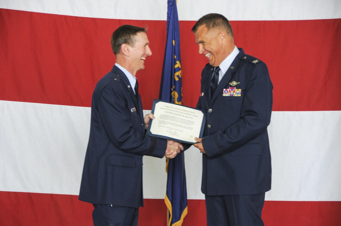 170603-Z-BD327-068: U.S. Air Force Col. Daniel Skotte, the commander of the146th Airlift Wing Medical Group, accepts his certificate of retirement from Brig. Gen. Clay Garrison, the commander of the California Air National Guard, at Kingsley Field, June 3, 2017. Skotte tallies just days short of a full 50 years of service and is likely the longest serving Airman to date. (U.S. Air National Guard photo by Senior Airman Riley Johnson)