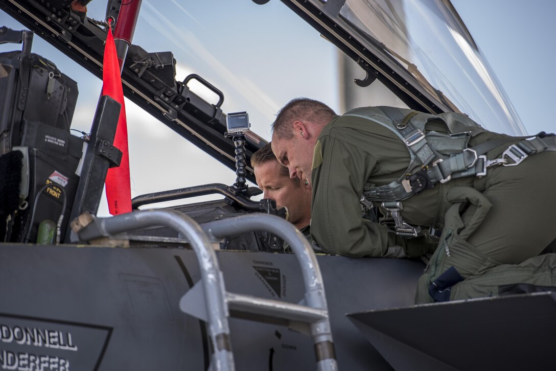 Col. Jefferson O'Donnell, 366th Fighter Wing commander, assists with getting Rich Sykes, Mountain Home mayor, situated in his seat, June 2, 2017, at Mountain Home Air Force Base, Idaho. During the orientation flight Sykes flew in the weapons system operator's seat.(U.S. Air Force Photo by Senior Airman Jeremy L. Mosier)