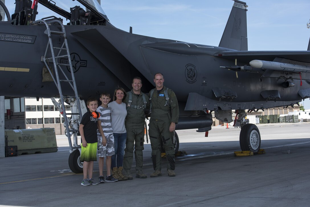 Col. Jefferson O'Donnell, 366th Fighter Wing commander, poses for a photo with Rich Sykes, Mountain Home mayor, and his family, June 2, 2017, at Mountain Home Air Force Base, Idaho. Sykes' family was there to watch him take off and land during his orientation flight.(U.S. Air Force Photo by Senior Airman Jeremy L. Mosier)