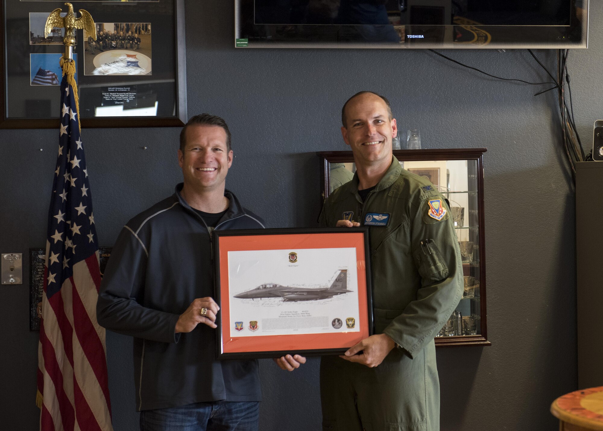 Col. Jefferson O'Donnell, 366th Fighter Wing commander, poses for a photo with Rich Sykes, Mountain Home mayor, June 2, 2017, at Mountain Home Air Force Base, Idaho. O'Donnell presented Sykes with a photo of an F-15E Strike Eagle that was signed by the aircrew after his orientation flight.(U.S. Air Force Photo by Senior Airman Jeremy L. Mosier)
