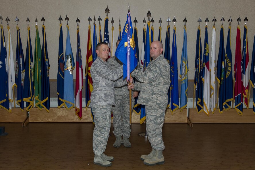 U.S. Air Force Lt. Col. Erik Haynes, the 66th Training Squadron (TRS) commander, left, receives the Detachment 1, 66th TRS guidon from Lt. Col. William Mercer, the former Det. 1, 66th TRS commander, during a change of command ceremony June 9, 2017, at Eielson Air Force Base, Alaska. Mercer will go on to serve as the director of operations for the 22nd TRS at Fairchild Air Force Base, Washington. (U.S. Air Force photo by Airman Eric Michael Fisher)
