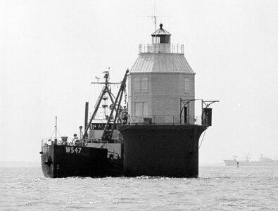 Baltimore Light, Maryland; no photo number; caption: "Installation of 4,600 [pound] atomic generator SNAP-7B in Baltimore Light by U.S. Coast Guard buoy tender WHITE PINE"; 20 May 1964; photo by "Meyer, PHC, USCG."