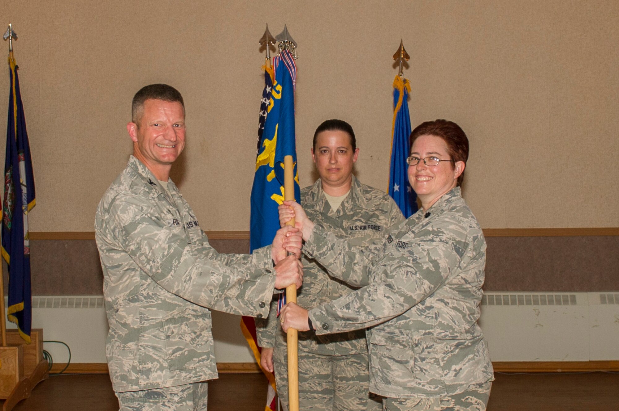 U.S. Air Force Col. William Fecke, the 354th Medical Group commander, passes the 354th Medical Operations Squadron (MDOS) guidon to Lt. Col. Valerie O’Brien, the new 354th MDOS commander, June 8, 2017, at Eielson Air Force Base, Alaska. O’Brien took command from Col. Mark Anderson, who will go on to serve as the 55th MDOS commander at Offutt Air Force Base, Nebraska. (U.S. Air Force photo by Airman 1st Class Isaac Johnson)