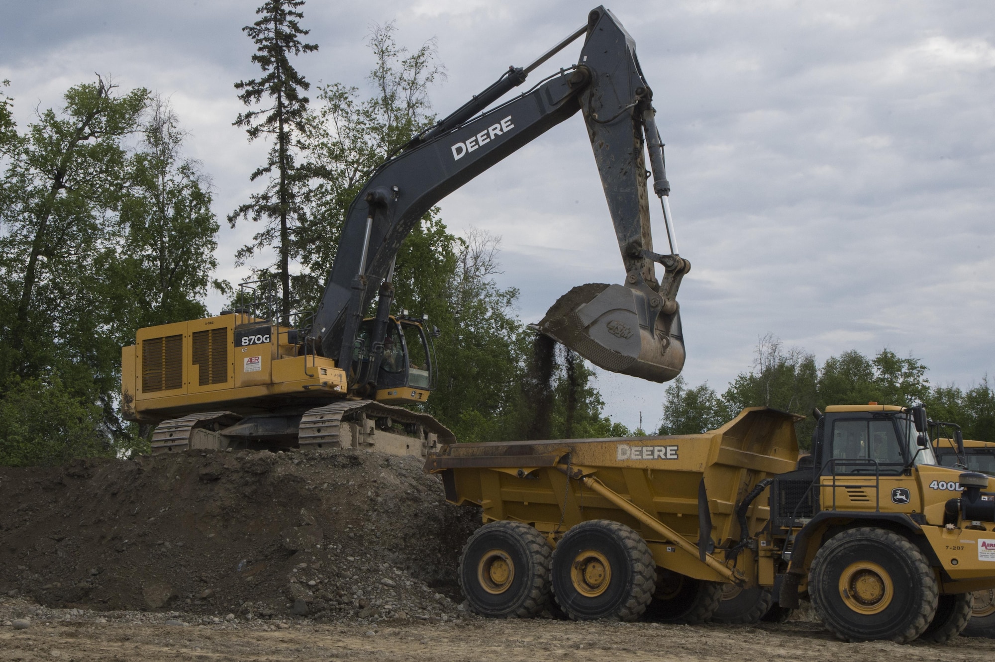 Members of the 819th RED HORSE Squadron operate an excavator, bulldozer and a dump trucks  during Phase I of the north-south runway at Joint Base Elmendorf-Richardson, Alaska, June 9, 2017. During their three-month stay, they play to move a minimum of 850,000 cubic yards. (U.S. Air Force photo by Staff Sgt. Sheila deVera)