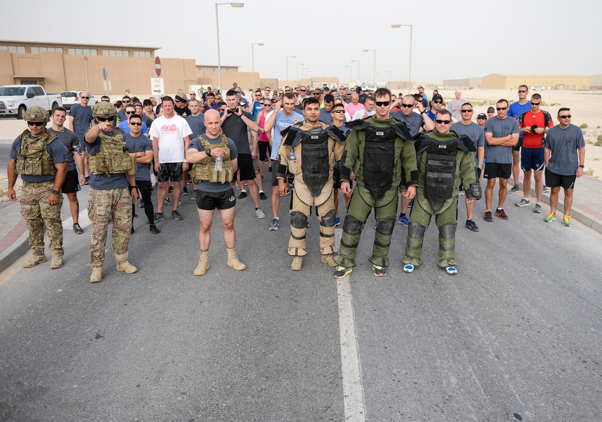 Dressed in bomb suits, U.S. Air Force Senior Airman Cory McLellan, left, and Staff Sgts. Brent Points center, and Jason Evans, right, explosive ordinance disposal technicians assigned to the 379th Civil Engineering Squadron, prepare to lead a group of runners during the annual EOD 5K Memorial Run at Al Udeid Air Base, Qatar, June 3, 2017. Service members from across the base gathered to take part in the EOD 5K Memorial Run in memory of the EOD men and women killed in action during combat operations. (U.S. Air Force photo by Tech. Sgt. Bradly A. Schneider/Released)