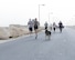 U.S. Air Force Senior Airman Stephen Sanchez, a military working dog handler assigned to the 379th Expeditionary Security Forces Squadron, front, left of center, and his military working dog Edy take part in the annual Explosive Ordinance Disposal 5K Memorial Run at Al Udeid Air Base, Qatar, June 3, 2017. Service members from across the base gathered to take part in the EOD 5K Memorial Run in memory of the EOD men and women killed in action during combat operations. (U.S. Air Force photo by Tech. Sgt. Bradly A. Schneider/Released)