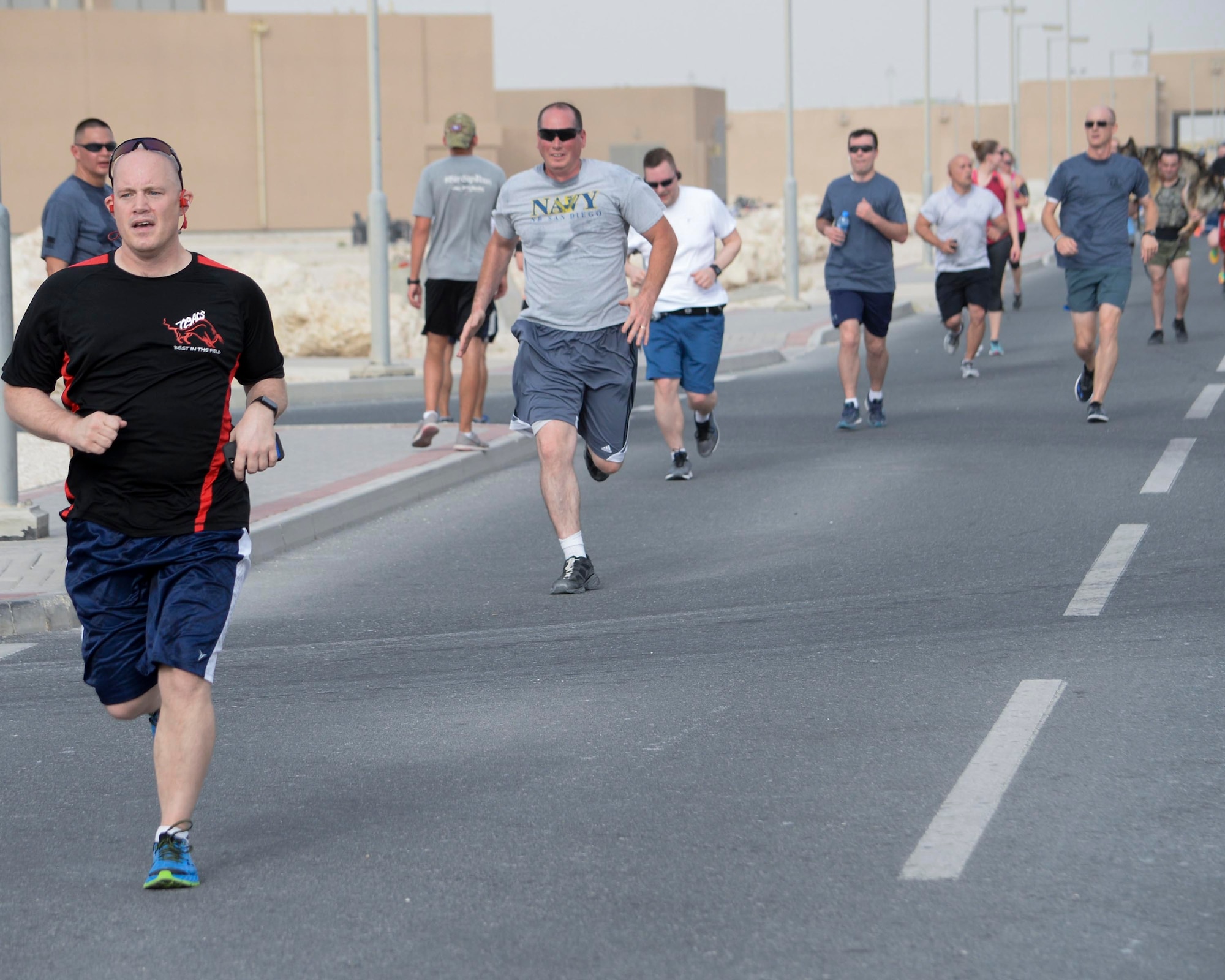 Military members participate in the annual Explosive Ordinance Disposal 5K Memorial Run at Al Udeid Air Base, Qatar, June 3, 2017. Service members from across the base gathered to take part in the EOD 5K Memorial Run in memory of the EOD men and women killed in action during combat operations. (U.S. Air Force photo by Tech. Sgt. Bradly A. Schneider/Released)