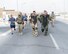 U.S. Air Force Senior Airman Cory McLellan, left, tan bomb suit, and Staff Sgt. Brent Points, right, green bomb suit, explosive ordinance technicians assigned to the 379th Civil Engineering Squadron approach the finish line while wearing bomb suits during the annual EOD 5K Memorial Run at Al Udeid Air Base, Qatar, June 3, 2017. McLellan and Points joined service members from across the base who gathered to take part in the EOD 5K Memorial Run in memory of the EOD men and women killed in action during combat operations. (U.S. Air Force photo by Tech. Sgt. Bradly A. Schneider/Released)