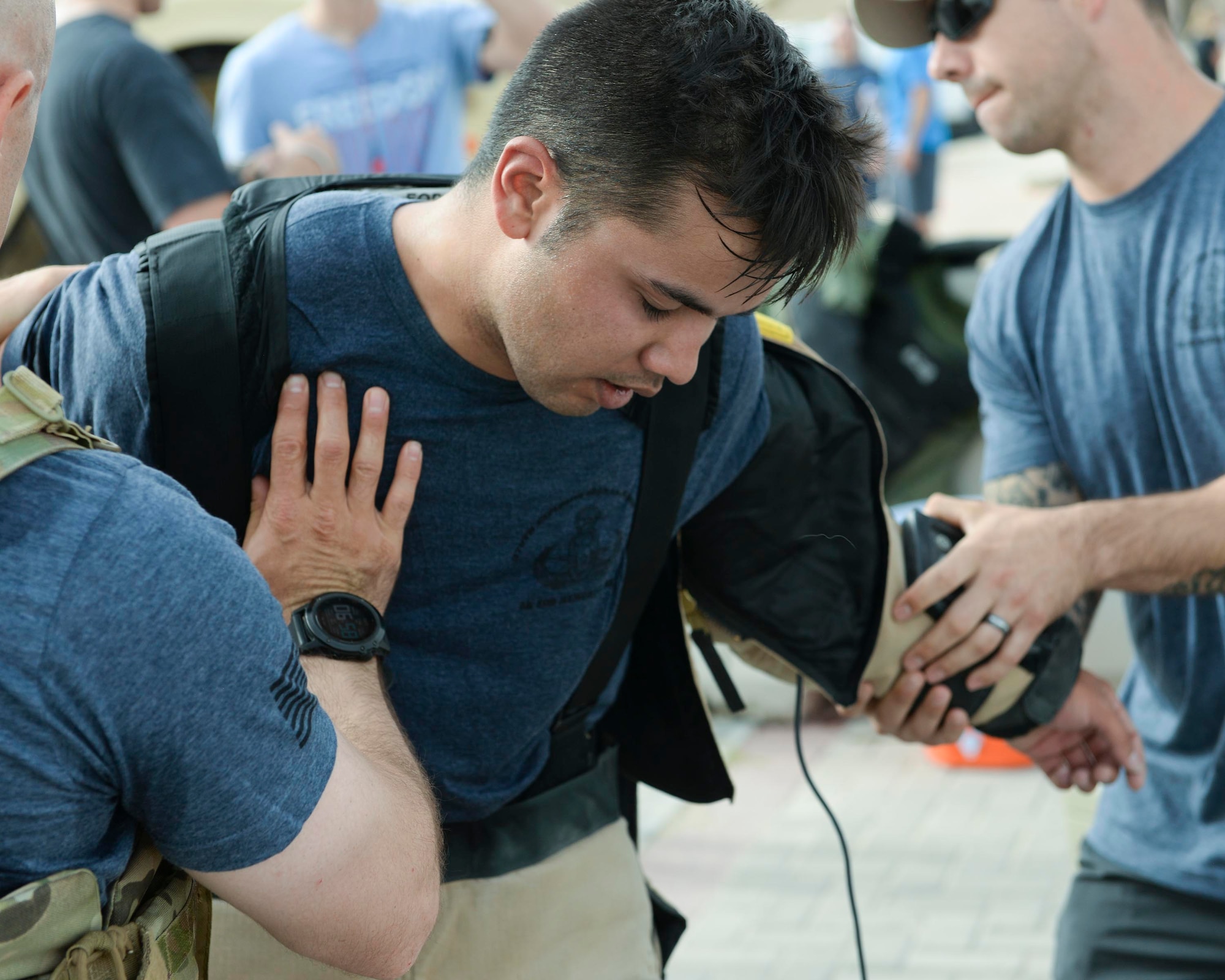 U.S. Air Force Senior Airman Cory McLellan, explosive ordinance disposal technician assigned to the 379th Civil Engineering Squadron, gets help removing the bomb suit he wore during the annual EOD 5K Memorial Run at Al Udeid Air Base, Qatar, June 3, 2017. McLellan joined service members from across the base who gathered to take part in the EOD 5K Memorial Run in memory of the EOD men and women killed in action during combat operations. (U.S. Air Force photo by Tech. Sgt. Bradly A. Schneider/Released)