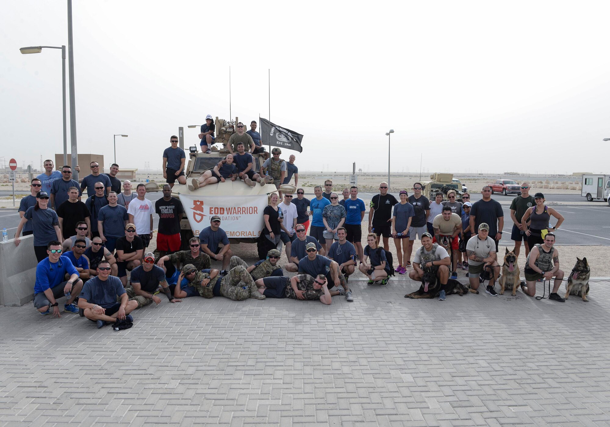 Service members who participated in the annual Explosive Ordinance Disposal 5K Memorial Run at Al Udeid Air Base, Qatar, June 3, 2017 pose for a group photograph after the run. Service members from across the base gathered to take part in the EOD 5K Memorial Run in memory of the EOD men and women killed in action during combat operations. (U.S. Air Force photo by Tech. Sgt. Bradly A. Schneider/Released)