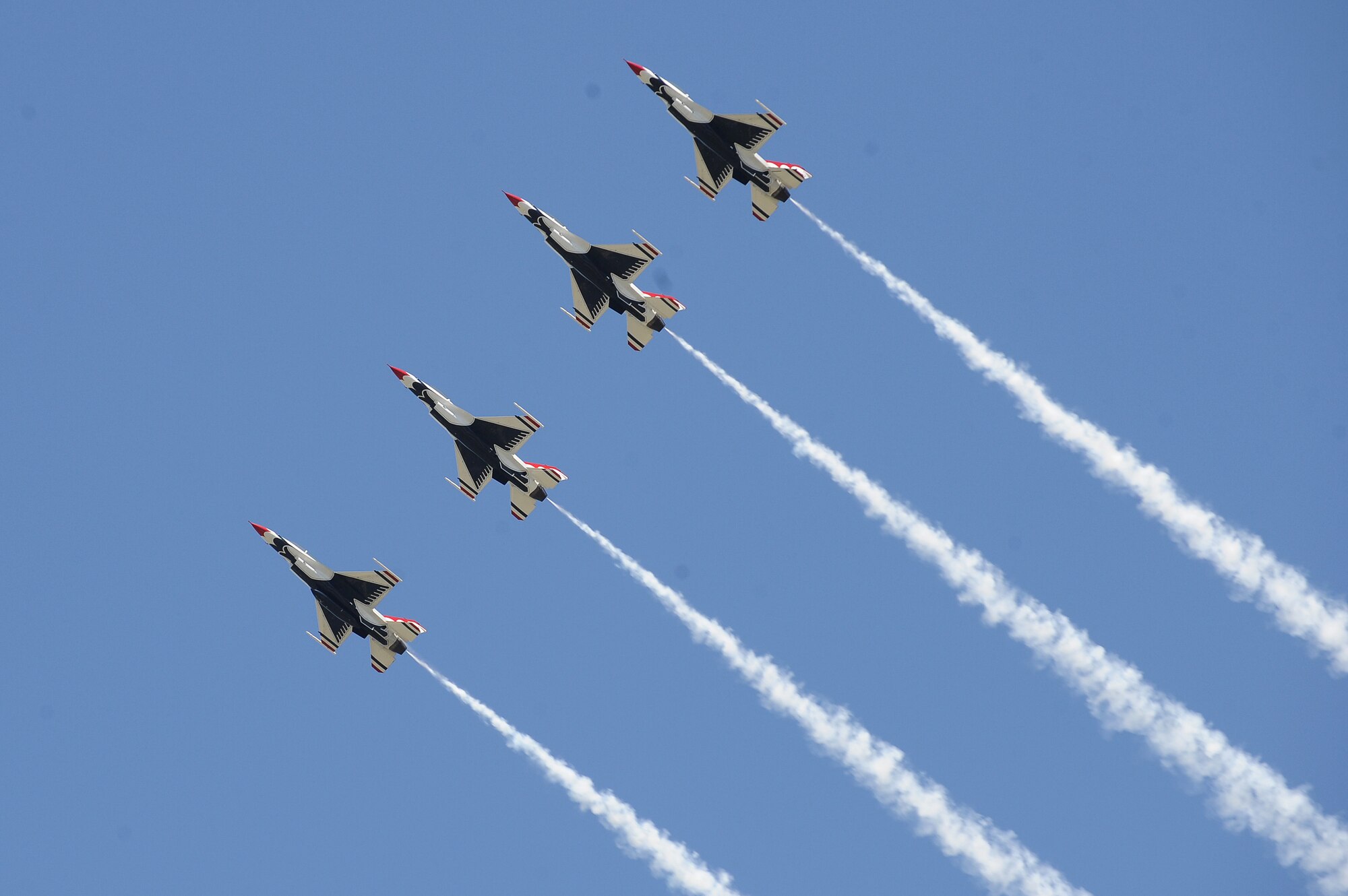 The Thunderbirds, officially known as the U.S. Air Force Air Demonstration Squadron, perform precision aerial maneuvers to demonstrate the capabilities the F-16 Fighter Falcon, the Air Force’s premier multi-role fighter jet, for special needs families, Scott Air Force Base, Ill., June 9, 2017.   To prepare for its demonstration role, the only modifications needed are installing a smoke-generating system in the space normally reserved for the 20mm cannon and the painting of the aircraft in Thunderbird colors. Since the team’s inception, 325 officers have worn the distinguished emblem of “America’s Ambassadors in Blue” and over 300 million people have witnessed their show.  . (U.S. Air Force photo by Tech. Sgt. Maria Castle)