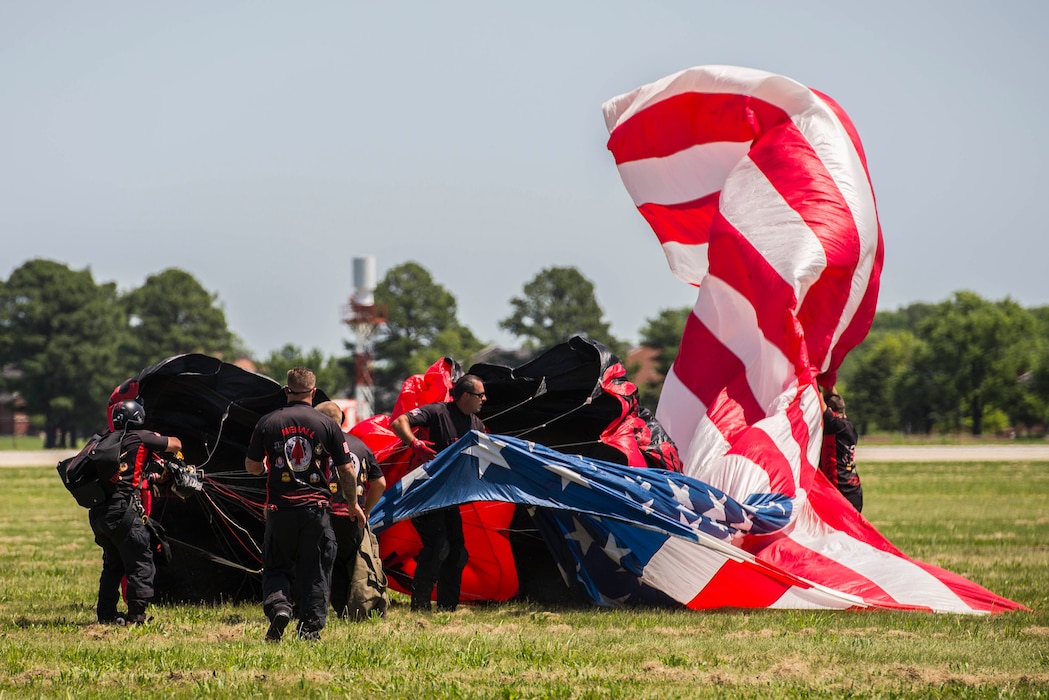 Members of the Black Daggers, the official U.S. Army Special Operations Command Parachute Demonstration Team, perform aerial stunts during Scott Air Force Base 2017 Air Show and Open House June 9, which celebrates the base’s 100th anniversary.  The black daggers use the military variant of the ram-air parachute, which is a flexible-wing glider.  This allows a free-fall parachutist the ability to jump with more than 100 pounds of additional equipment.(U.S. Air Force photo/Senior Airman Tristin English)