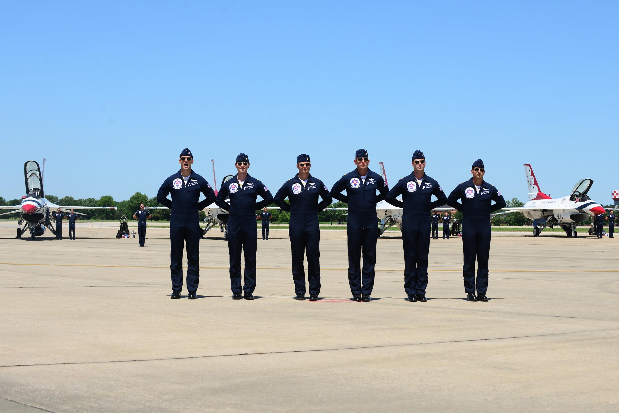 Thunderbird members perform a pre-show ground demonstration at Scott Air Force Base, Ill., June 9, 2017. The Thunderbirds, officially known as the U.S. Air Force Air Demonstration Squadron, performs precision aerial maneuvers to demonstrate the capabilities the F-16 Fighter Falcon, the Air Force’s premier multi-role fighter jet, Scott Air Force Base, Ill., June 9, 2017.   Eight highly experienced fighter pilots, four support officers, three civilians, and over 120 enlisted personnel help make it possible for the team to showcase the capabilities of this fighter jet to millions of people each year.  Together, this team has ensured that a demonstration has never been cancelled due to maintenance difficulty.  (U.S. Air Force photo by Tech. Sgt. Maria Castle)