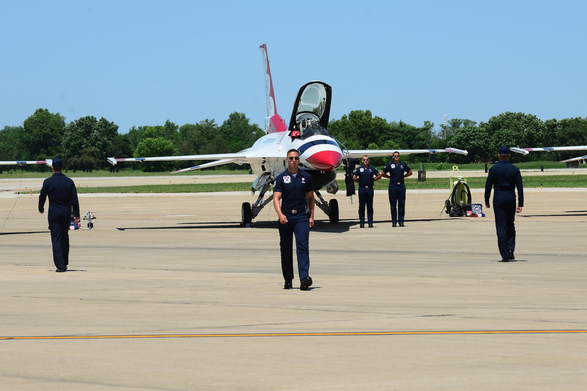 Thunderbird members perform a pre-show ground demonstration at Scott Air Force Base, Ill., June 9, 2017. The Thunderbirds, officially known as the U.S. Air Force Air Demonstration Squadron, performs precision aerial maneuvers to demonstrate the capabilities the F-16 Fighter Falcon, the Air Force’s premier multi-role fighter jet, Scott Air Force Base, Ill., June 9, 2017.   Eight highly experienced fighter pilots, four support officers, three civilians, and over 120 enlisted personnel help make it possible for the team to showcase the capabilities of this fighter jet to millions of people each year.  Together, this team has ensured that a demonstration has never been cancelled due to maintenance difficulty.  (U.S. Air Force photo by Tech. Sgt. Maria Castle)