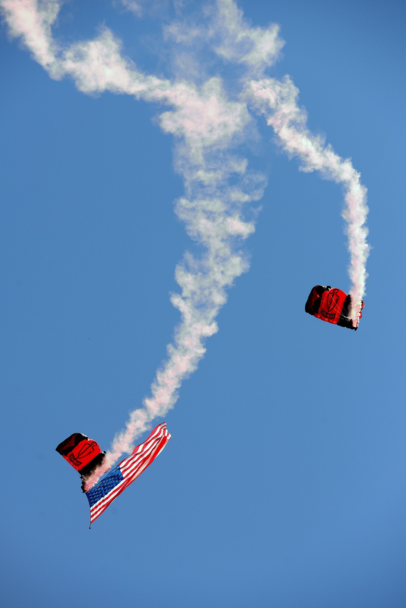 Members of the Black Daggers, the official U.S. Army Special Operations Command Parachute Demonstration Team, perform aerial stunts during Scott Air Force Base 2017 Air Show and Open House June 9, 2017, which celebrates the base’s 100th anniversary.  Black Daggers are highly trained Soldiers who insert themselves behind enemy lines to disrupt the movement of enemy troops and supplies to the front lines.  They frequently use parachutes to infiltrate without being detected. (U.S. Air Force photo by Tech. Sgt. Jonathan Fowler)