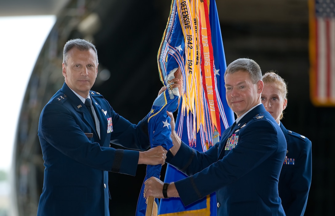 Maj. Gen. Randall A. Ogden (left), 4th Air Force commander, passes the 512th Airlift Wing guidon to Col. Craig C. Peters, June 10, 2017, during a change of command ceremony on Dover Air Force Base, Delaware. Ogden was the presiding official of the ceremony. (U.S. Air Force photo/ Roland Balik)