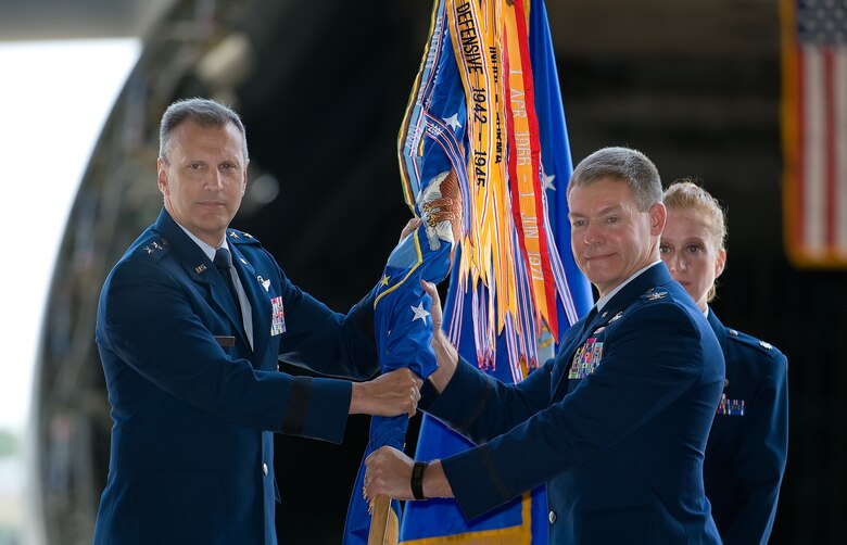 Maj. Gen. Randall A. Ogden (left), 4th Air Force commander, passes the 512th Airlift Wing guidon to Col. Craig C. Peters, June 10, 2017, during a change of command ceremony on Dover Air Force Base, Delaware. Ogden was the presiding official of the ceremony. (U.S. Air Force photo/ Roland Balik)