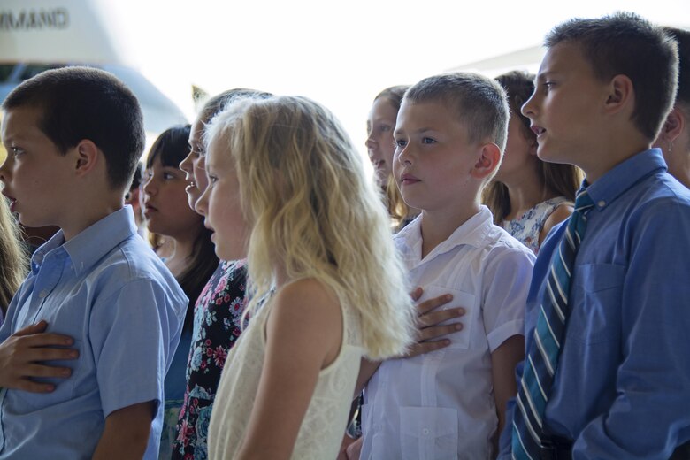 Children from the Major George S. Welch Elementary School chorous sing the National Anthem before the start of the 512th Airlift Wing's Change of Command ceremony on Dover Air Force Base, Delaware, June 10, 2017. Col. Craig C. Peters assumed command of the 512th Airlift Wing in a ceremony today inside an aircraft hangar here. (U.S. Air Force photo/ Staff Sgt. Renee Jackson)