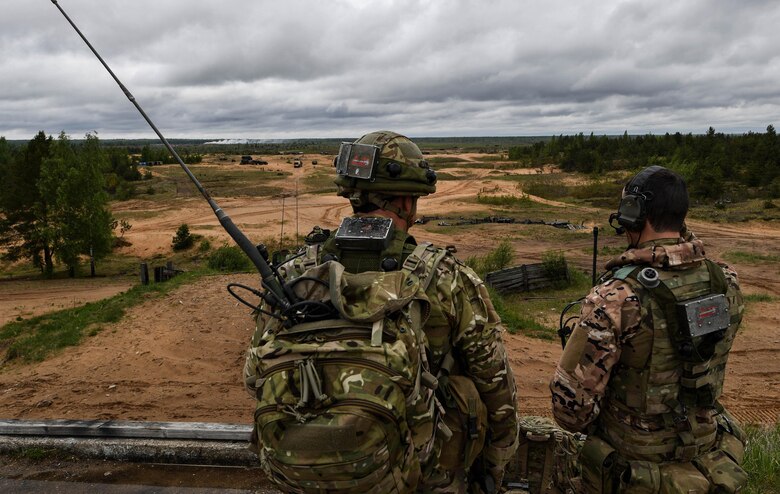 Great Britain Royal Marine joint terminal attack controllers call in military aircraft during exercise Saber Strike 17 at Adazi Military Base, Latvia, June 5, 2017. During the exercise, U.S. and NATO JTACs controlled air strike operations with U.S. Air Force F-16 Fighting Falcons, a B-52 Stratofortress, and a B-1B Lancer. Saber Strike 17 highlights the inherent flexibility of ground and air forces to rapidly respond to crises allowing for the right presence where it is needed, when it is needed. (U.S Air Force photo by Senior Airman Tryphena Mayhugh)
