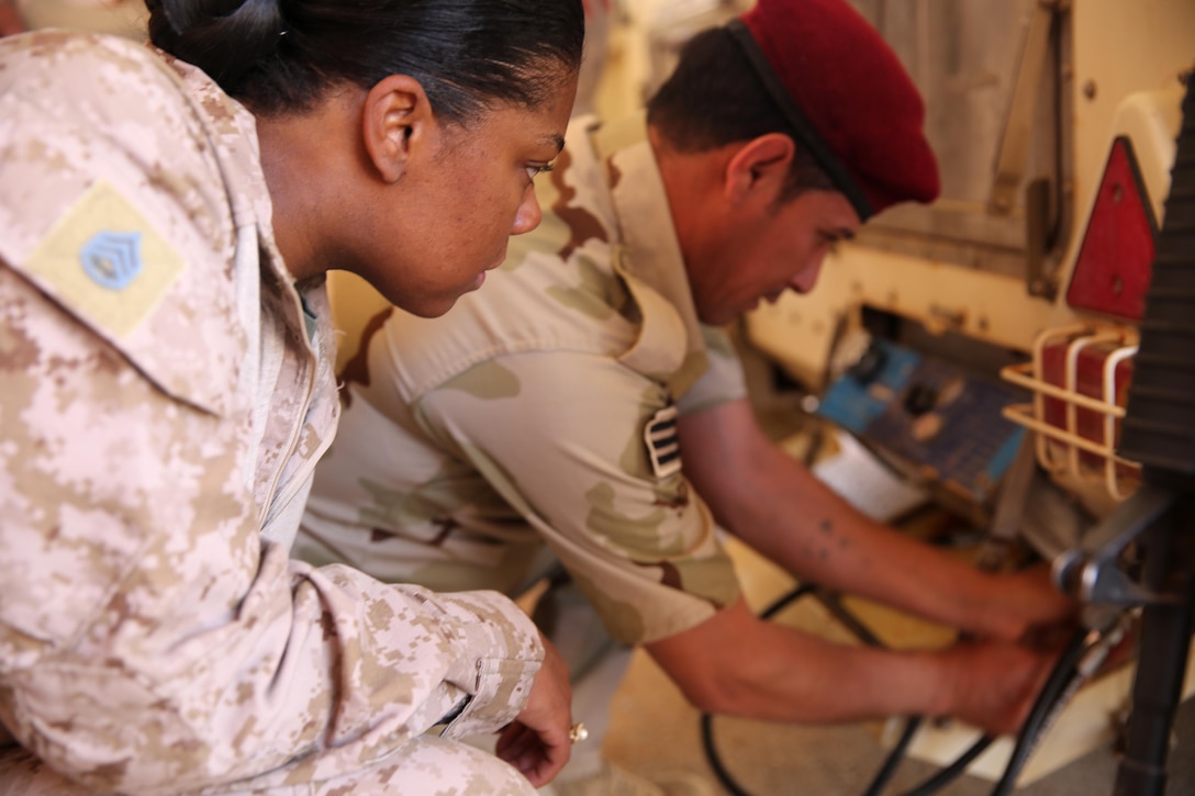 U.S. Marine Corps Staff Sgt. Shakelia Woods, a food service specialist with Special Purpose Marine Air-Ground Task Force-Crisis Response-Central Command, observes an Iraqi soldier with the 7th Iraqi Army Division conduct a maintenance check on an Ozti Field Kitchen (OFK) during an advise and assist mission in support of Task Force Al Asad in Iraq May 4, 2017. Task Force Al Asad trains Iraqi forces with operationally relevant training, an integral aspect of Combined Joint Task Force-Operation Inherent Resolve, the global coalition to defeat ISIS in Iraq and Syria. (U.S. Marine Corps photo by Staff Sgt. Jennifer B. Poole) 