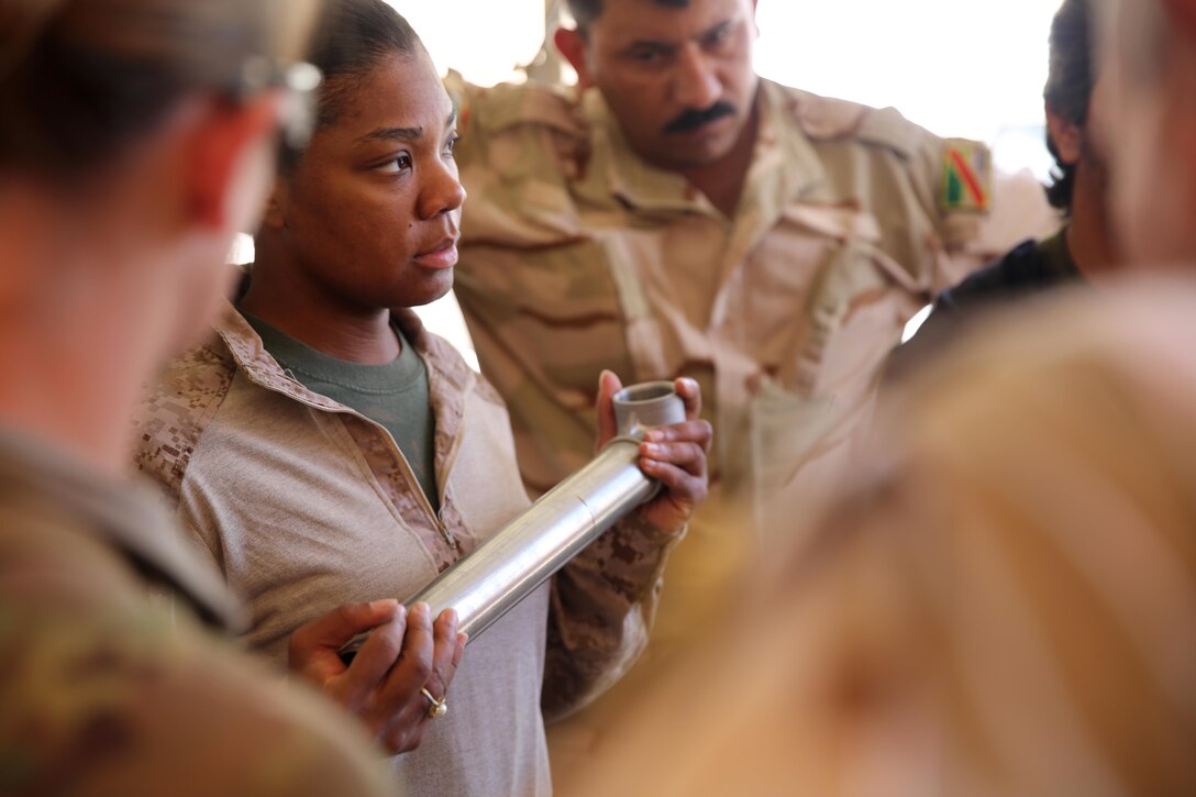 U.S. Marine Corps Staff Sgt. Shakelia Woods, a food service specialist with Special Purpose Marine Air-Ground Task Force-Crisis Response-Central Command, discusses preventive maintenance on an Ozti Field Kitchen (OFK) to Iraqi soldiers with the 7th Iraqi Army Division during an advise and assist mission in support of Task Force Al Asad in Iraq May 4, 2017. Task Force Al Asad trains Iraqi forces with operationally relevant training, an integral aspect of Combined Joint Task Force-Operation Inherent Resolve, the global coalition to defeat ISIS in Iraq and Syria.(U.S. Marine Corps photo by Staff Sgt. Jennifer B. Poole) 