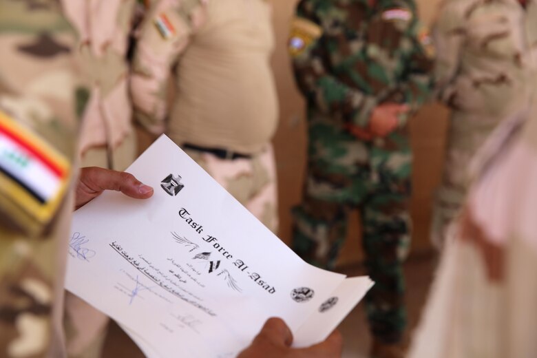An Iraqi soldier with the 7th Iraqi Army Division holds a certificate of accomplishment after completing a week-long course on capabilities and employment of an Ozti Field Kitchen (OFK) taught by U.S. Marine Corps Staff Sgt. Shakelia Woods, a food service specialist with Special Purpose Marine Air-Ground Task Force-Crisis Response-Central Command, April 30-May 4, 2017. Task Force Al Asad trains Iraqi forces with operationally relevant training, an integral aspect of Combined Joint Task Force-Operation Inherent Resolve, the global coalition to defeat ISIS in Iraq and Syria.(U.S. Marine Corps photo by Staff Sgt. Jennifer B. Poole)