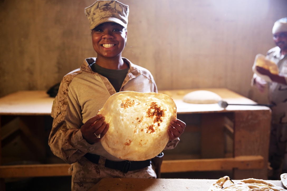 U.S. Marine Corps Staff Sgt. Shakelia Woods, a food service specialist with Special Purpose Marine Air-Ground Task Force-Crisis Response-Central Command, showcases khubuz, a traditional Iraqi flat bread, at Al Asad Air Base, Iraq, May 4, 2017. Woods instructed Iraqi soldiers with the 7th Iraqi Army Division on capabilities and employment of an Ozti Field Kitchen (OFK) during an advise and assist mission in support of Task Force Al Asad. Task Force Al Asad trains Iraqi forces with operationally relevant training, an integral aspect of Combined Joint Task Force-Operation Inherent Resolve, the global coalition to defeat ISIS in Iraq and Syria. (U.S. Marine Corps photo by Staff Sgt. Jennifer B. Poole) 