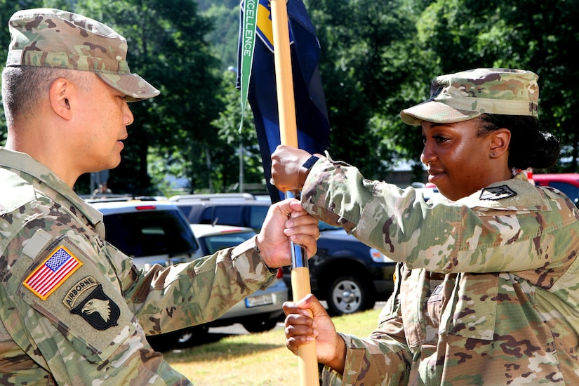 Capt. Ayahna N. Killings (right), commander of the Headquarters and Headquarters Company, 7th Mission Support Command, receives the unit guidon from Col. Alexis M. Wells, deputy commanding officer of the 7th Mission Support Command, in a change of command ceremony Saturday June 10, 2017 at Daenner Kaserne in Kaiserslautern, Germany. 