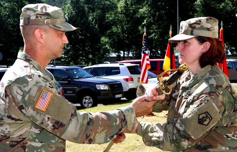 First Sgt. Nikki S. Orr (right), the first sergeant of Headquarters and Headquarters Company, 7th Mission Support Command, receives the unit sword from Command Sgt. Maj. Raymond L. Brown, the senior enlisted leader of the 7th MSC during a change of responsibility ceremony Saturday June 10, 2017 at Daenner Kaserne in Kaiserslautern, Germany. 