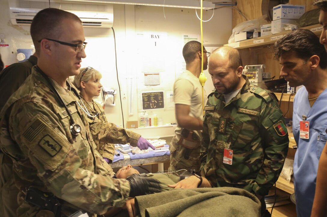 A U.S. Army trauma surgeon with 2nd Forward Surgical Team, U.S. Forces-Afghanistan demonstrates proper chest tube placement on a simulated casualty to Afghan National Army medical personnel at Camp Shorab, Afghanistan, June 7, 2017. A team of more than 10 FST soldiers collaborated with ANA medical personnel to demonstrate trauma procedures in preparation for potential battlefield casualties. (U.S. Marine Corps photo by Sgt. Lucas Hopkins)