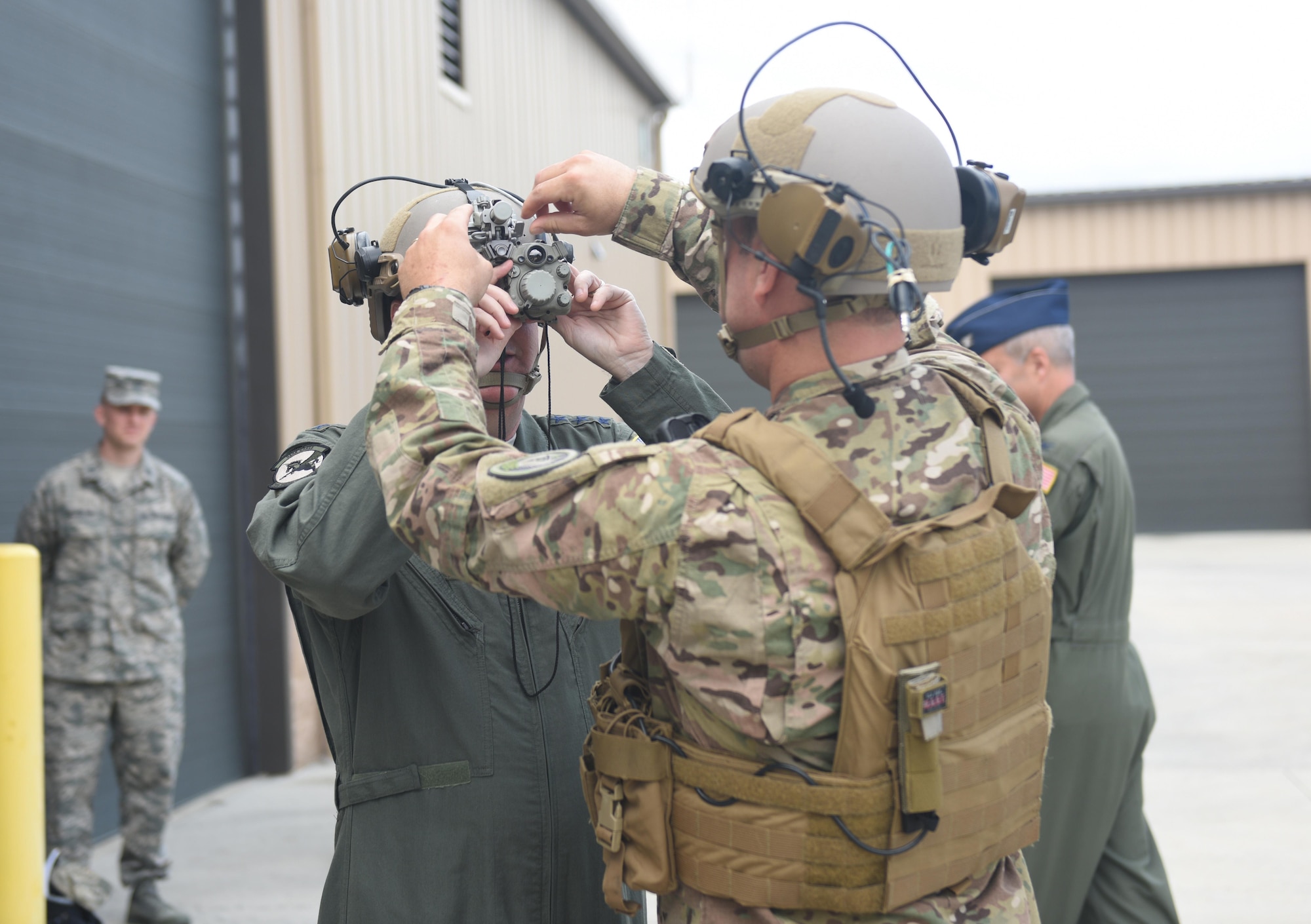 During a tour June 10, 2017, of the 193rd Special Operations Wing, Middletown, Pennsylvania, Staff Sgt. Shawn Kobel, a security forces specialist with the 193rd Special Operations Security Forces Squadron, shows U.S. Air Force Lt. Gen. Brad Webb (left), commander of Air Force Special Operations Command, how troops wear and operate the op-score helmet. These helmets are relatively new to the unit and include earmuffs and a radio, as well as nighttime and thermal vision. (U.S. Air National Guard photo by Senior Airman Julia Sorber/Released)