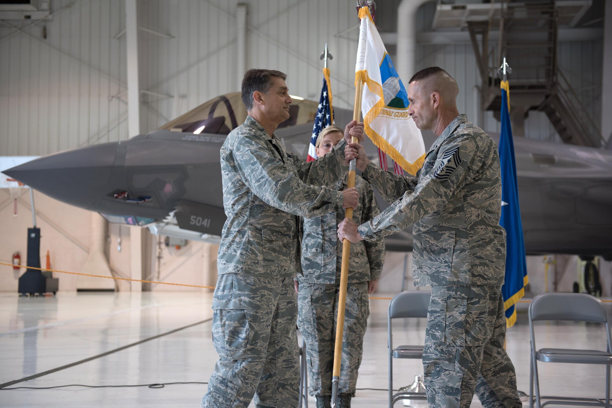 Chief Master Sgt. Ray Dawson (right) accepts the guidon of Headquarters, Kentucky Air National Guard, from Brig. Gen. Warren Hurst, Kentucky’s assistant adjutant general for Air, to become the Commonwealth’s newest state command chief during a ceremony at the Kentucky Air National Guard Base in Louisville, Ky., April 22, 2017. Dawson replaces Chief Master Sgt. Jeff Moore, who is retiring after more than 35 years of service to the United States Air Force and Kentucky Air Guard. (Kentucky Air National Guard photo by 1st Lt. James W. Killen)