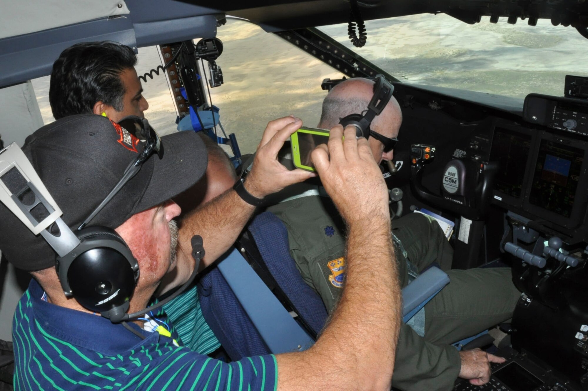 Ray Freitas, San Antonio Fire Department, takes a photo with his phone of the scenic view along the Texas coastline during the 433rd Airlift Wing’s Boss Lift June 10, 2017.  The Boss Lift, which is sponsored by the Employer Support of the Guard and Reserve, promotes cooperation and understanding between Reserve component service members and their civilian employers. (U.S. Air Force photo/Senior Airman Bryan Swink)