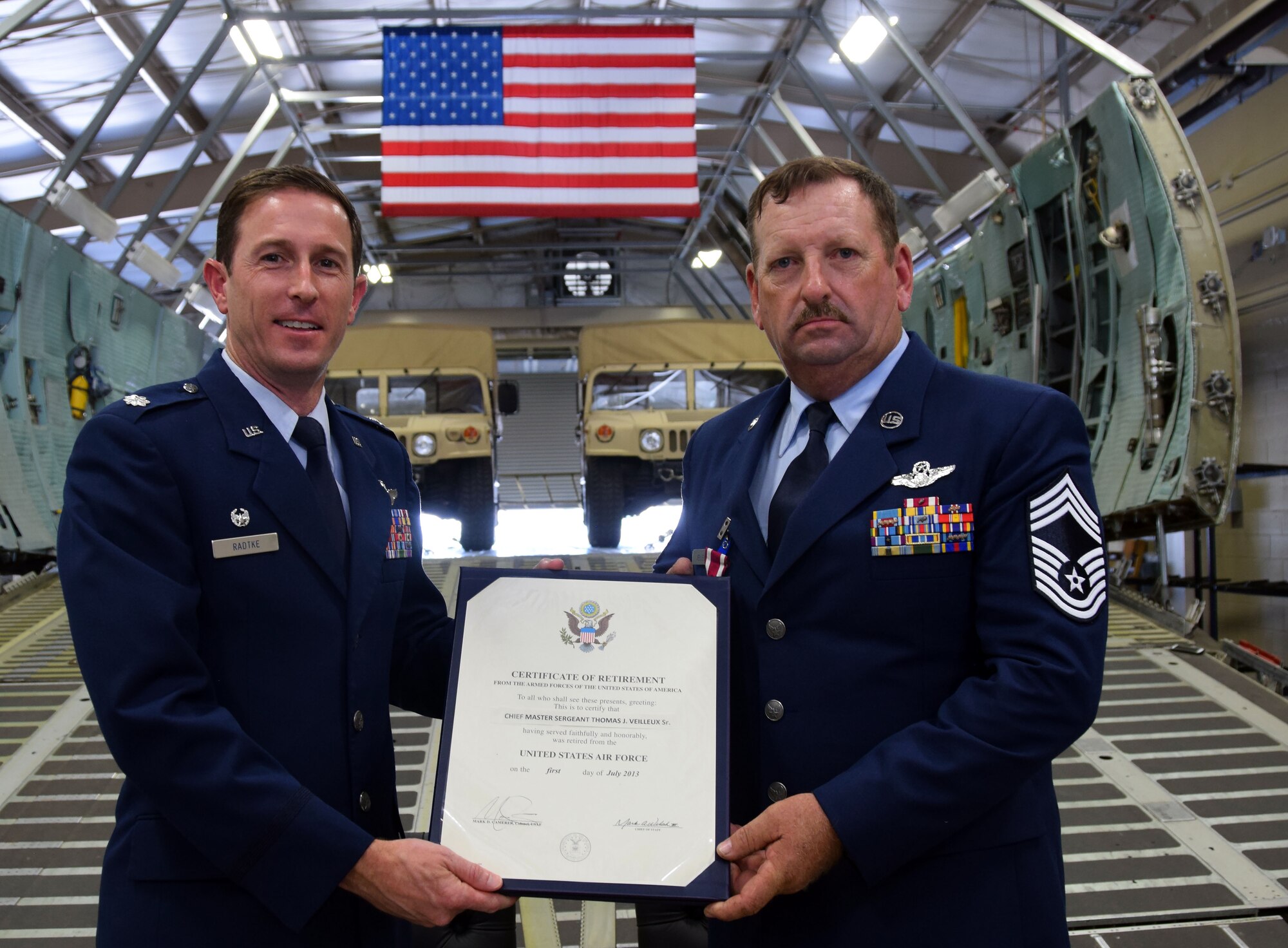 Lt. Col. Steven Radtke, 356th Airlift Squadron commander, presents the retirement certificate to Chief Master Sgt. Thomas J. Veilleux Sr., 356th Airlift Squadron’s Formal Training Unit superintendent, at the Cargo Loading Training Facility at Joint Base San Antonio-Lackland, Texas June 11, 2017. (U.S. Air Force photo by Tech. Sgt. Carlos J. Trevino)