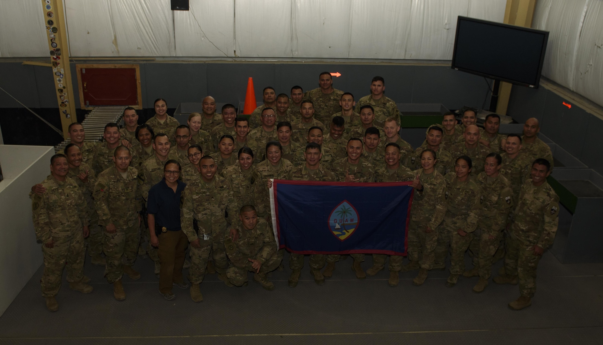 Service members pose for a group photo on Bagram Airfield, Afghanistan, June 7, 2017. Service members from Guam, which has the most military personnel per capita, have a large footprint in Afghanistan. Despite being only 210 square miles large and a having population of only 160,000, multiple service members and civilians from the Department of Defense and other government agencies currently serve in the region. (U.S. Air Force photo by Staff Sgt. Benjamin Gonsier)