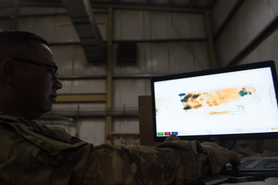 Spc. Frank Rivera, 368th Military Police Company, scans through luggage at Bagram Airfield, Afghanistan, April 30, 2017. The 368th Military Police Company runs two customs offices out of Bagram and Kandahar Airfields. (U.S. Air Force photo by Staff Sgt. Benjamin Gonsier)