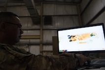 Spc. Frank Rivera, 368th Military Police Company, scans through luggage at Bagram Airfield, Afghanistan, April 30, 2017. The 368th Military Police Company runs two customs offices out of Bagram and Kandahar Airfields. (U.S. Air Force photo by Staff Sgt. Benjamin Gonsier)