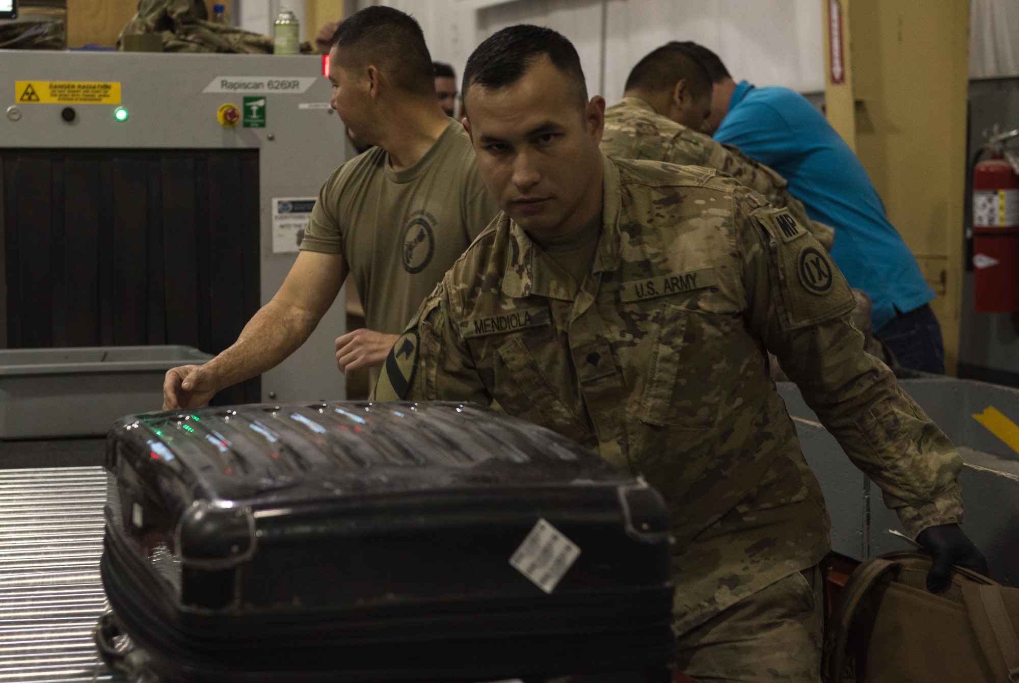 U.S. Army Spc. Adam Mendiola, 368th Military Police Company, pushes a piece of luggage after inspection at Bagram Airfield, Afghanistan, April 30, 2017. The customs office is responsible for inspecting personnel and cargo leaving Afghanistan and the Central Command area of responsibility. (U.S. Air Force photo by Staff Sgt. Benjamin Gonsier)  