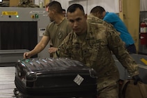 U.S. Army Spc. Adam Mendiola, 368th Military Police Company, pushes a piece of luggage after inspection at Bagram Airfield, Afghanistan, April 30, 2017. The customs office is responsible for inspecting personnel and cargo leaving Afghanistan and the Central Command area of responsibility. (U.S. Air Force photo by Staff Sgt. Benjamin Gonsier)  