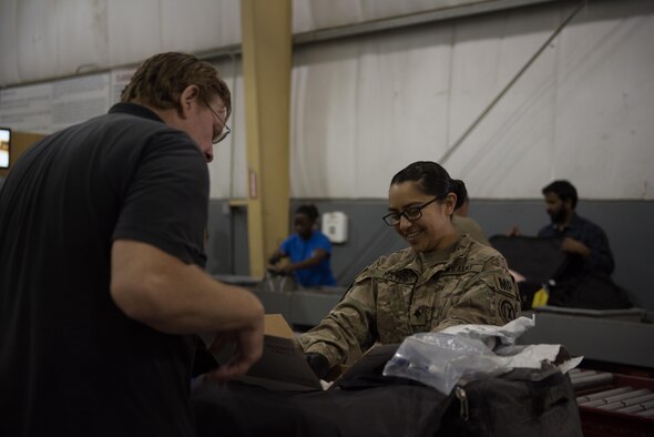 U.S. Army Spc. Michelle Mateo, 368th Military Police Company, inspects the contents inside a piece of luggage at Bagram Airfield, Afghanistan, April 30, 2017. During their inspections, the customs team follows strict guidelines of multiple governmental agencies to include the U.S. Customs and Border Protection, U.S. Department of Agriculture and Bureau of Alcohol, Tobacco, Firearms and Explosives when searching through luggage.  (U.S. Air Force photo by Staff Sgt. Benjamin Gonsier)