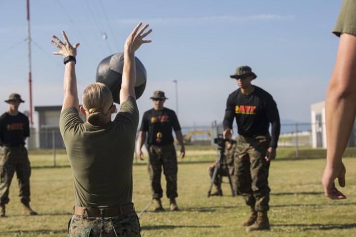 U.S. Marine Corps Gunnery Sgt. Carrie White, the Provost Marshal’s Office training chief with Headquarters and Headquarters Squadron, performs the kneeling power-ball throw during the third annual High Intensity Tactical Training championship preliminaries at Marine Corps Air Station Iwakuni, Japan, June 9, 2017. The event brought together the Marine Corps’ toughest male and female athletes to face off in obstacles that test their speed, endurance, strength and agility. Preliminary winners are slated to fly from their respective installations to compete at Marine Corps Base Camp Pendleton, California, August 28-31, 2017, to be crowned the ‘Ultimate Tactical Athlete.’ (U.S. Marine Corps photo by Lance Cpl. Mason Roy)