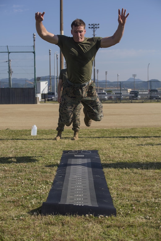 U.S. Marine Corps Lance Cpl. Austin Finch, a flight clearance dispatcher with Headquarters and Headquarters Squadron, conducts the standing broad jump during the third annual High Intensity Tactical Training championship preliminaries at Marine Corps Air Station Iwakuni, Japan, June 9, 2017. The event brought together the Marine Corps’ toughest male and female athletes to face off in obstacles that test their speed, endurance, strength and agility. Preliminary winners are slated to fly from their respective installations to compete at Marine Corps Base Camp Pendleton, California, August 28-31, 2017, to be crowned the ‘Ultimate Tactical Athlete.’ (U.S. Marine Corps photo by Lance Cpl. Mason Roy)