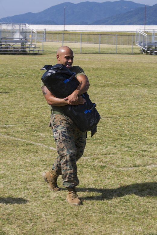 U.S. Marine Corps Lance Cpl. Jesus Olmedo, a warehouse clerk with Combat Logistics Company 36, conducts the 400 yard tactical shuttle during the third annual High Intensity Tactical Training championship preliminaries at Marine Corps Air Station Iwakuni, Japan, June 9, 2017. The event brought together the Marine Corps’ toughest male and female athletes to face off in obstacles that test their speed, endurance, strength and agility. Preliminary winners are slated to fly from their respective installations to compete at Marine Corps Base Camp Pendleton, California, August 28-31, 2017, to be crowned the ‘Ultimate Tactical Athlete.’ (U.S. Marine Corps photo by Lance Cpl. Mason Roy)