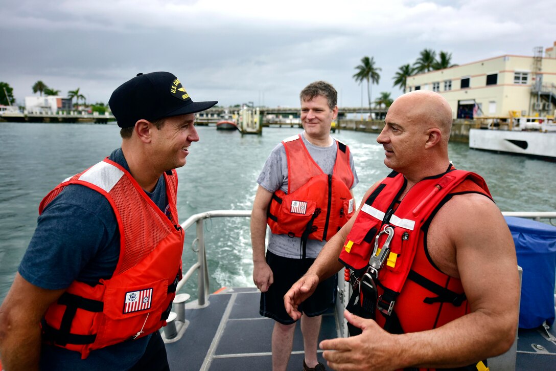Jim Cantore, right, Weather Channel storm tracker, and Coast Guard Petty Officer 1st Class Mikol Sullivan, left, to prepare for rescue training aboard a 45-foot response boat-medium at Miami Beach, Florida, June 6, 2017. Sullivan is a rescue swimmer assigned to Coast Guard Air Station Miami. Coast Guard photo by Petty Officer 3rd Class Eric D. Woodall