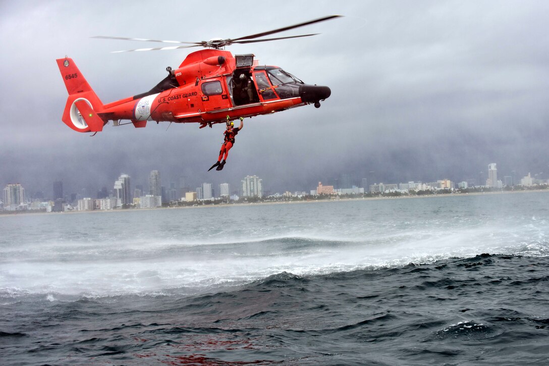 Coast Guard Petty Officer 3rd Class Bryan Evans performs a free fall from an MH-65 Dolphin helicopter during rescue training near Miami Beach, Florida, June 6, 2017. Evans is a rescue swimmer assigned to Coast Guard Air Station Miami. Coast Guard photo by Petty Officer 3rd Class Eric D. Woodall