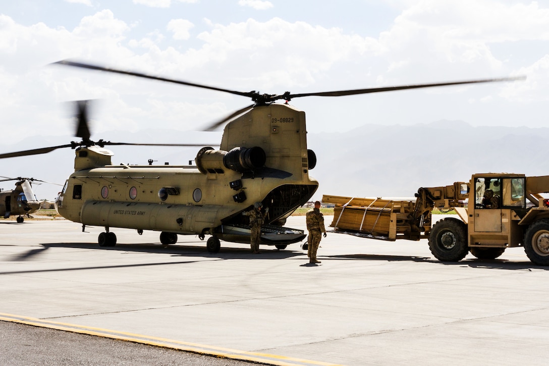 An Army crew chief directs a forklift loading cargo onto a CH-47 Chinook helicopter at Bagram Airfield, Afghanistan, June 9, 2017. Army photo by Capt. Brian Harris