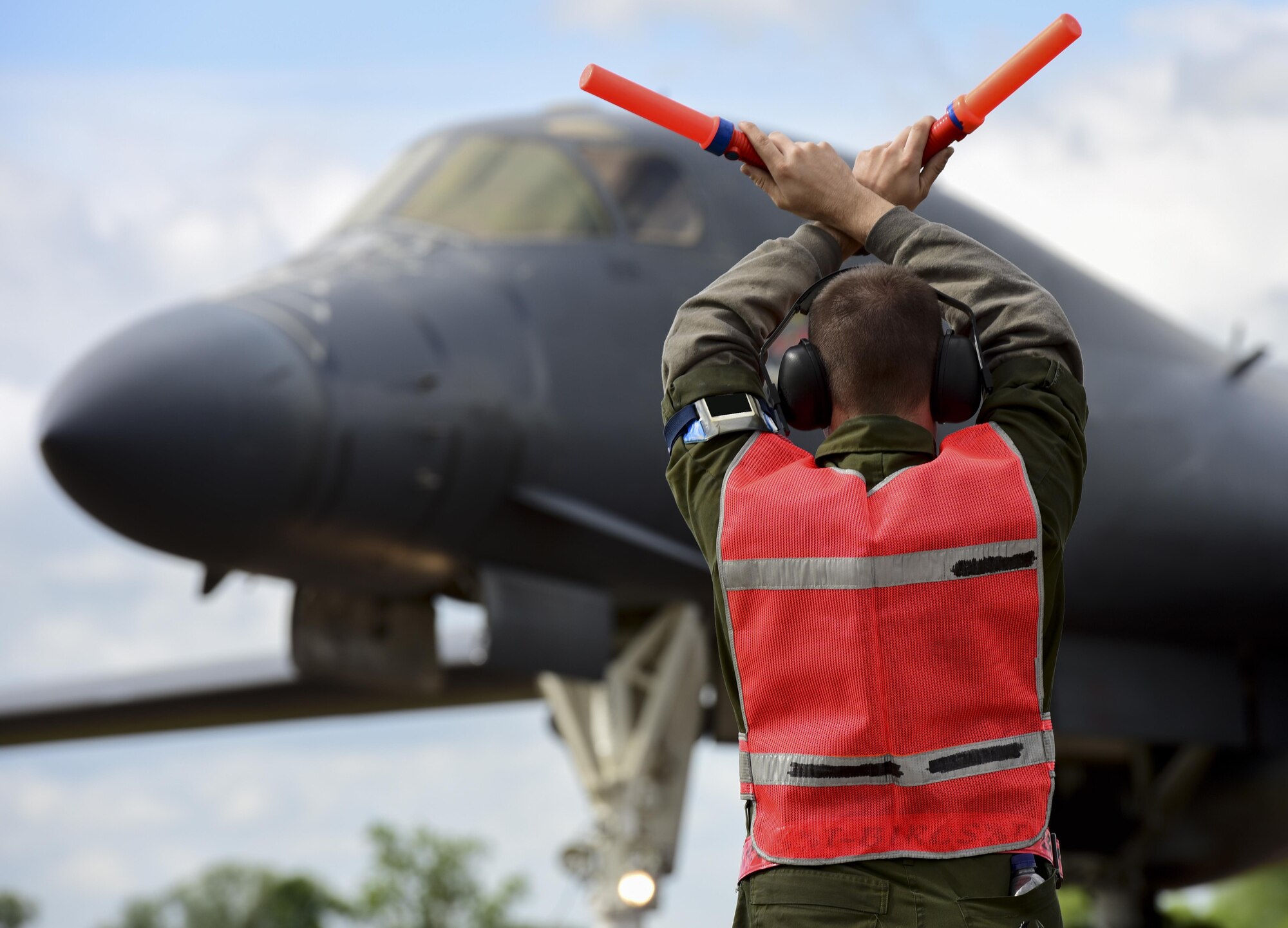 U.S. Air Force Airman 1st Class Jacob Feeback, 28th Aircraft Maintenance Squadron crew chief, marshals in a B-1B Lancer from Ellsworth Air Force Base at Royal Air Force Fairford, U.K., June 7, 2017. Airmen from the 28th Aircraft Maintenance Squadron are supporting bomber assurance and deterrence missions in the European theatre that combine training opportunities and greatly improve interoperability among participating NATO allies and regional partners. (U.S. Air Force photo by Airman 1st Class Randahl J. Jenson)