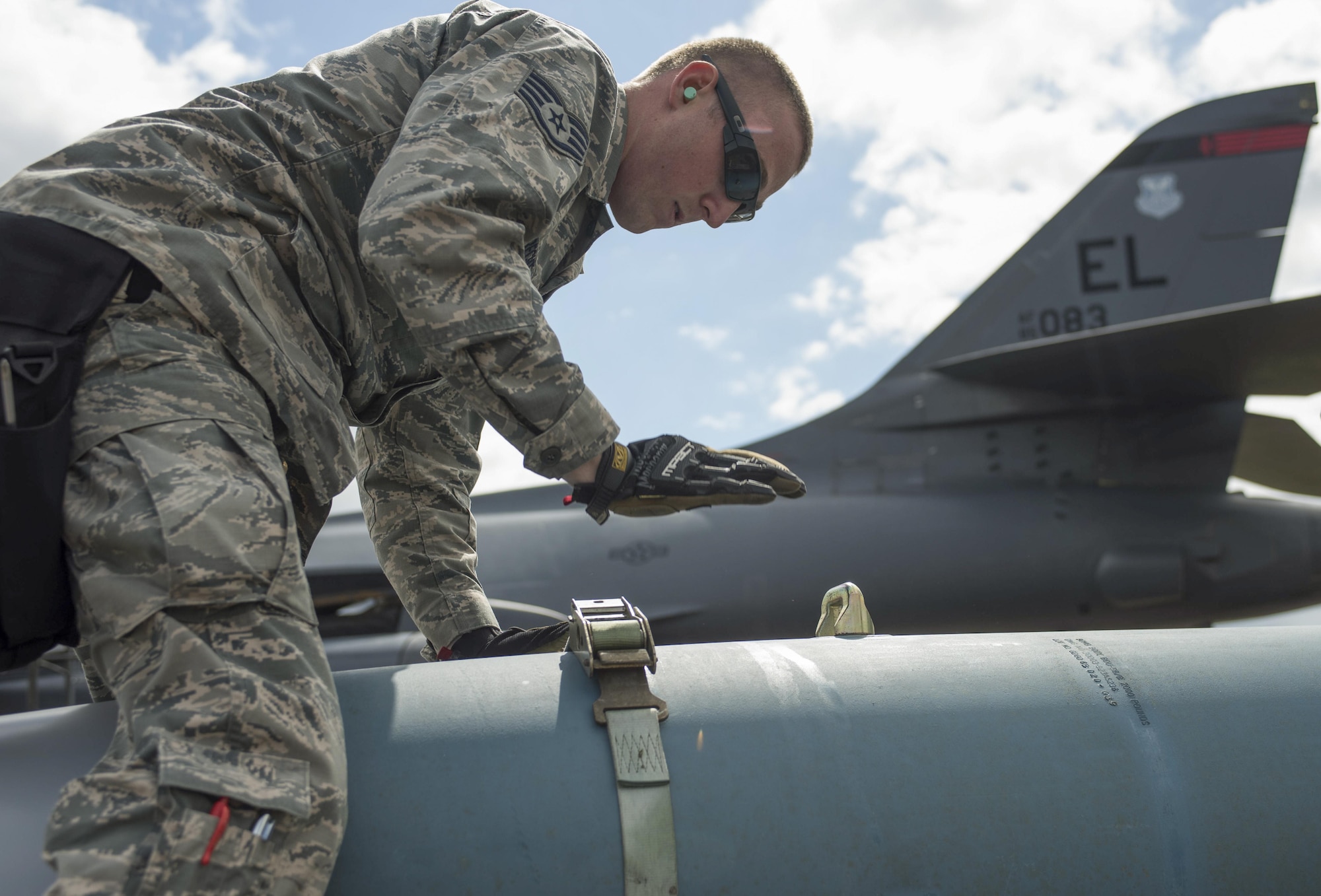 U.S. Air Force Staff Sgt. Matthew Milbrecht, 28th Aircraft Maintenance Squadron weapons load crew chief, straps down a BDU-56, (inert munition) a general purpose unguided conventional weapon, at Royal Air Force Fairford, U.K., June 7, 2017. Airmen from the 28th Aircraft Maintenance Squadron are supporting bomber assurance and deterrence missions in the European theatre that combine training opportunities and greatly improve interoperability among participating NATO allies and regional partners. (U.S. Air Force photo by Airman 1st Class Randahl J. Jenson)