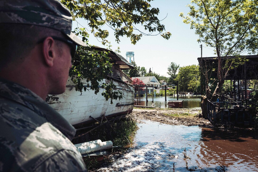 New York Air National Guard Staff Sgt. James McCormick checks the water flow being pumped from a local home in Olcott, N.Y., June 8, 2017. McCormick is assigned to the 107th Medical Group, Niagara Falls Air Reserve Station. Air National Guard photo by Staff Sgt. Ryan Campbell